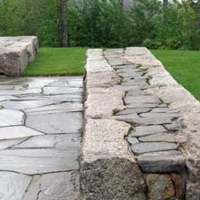 Artistically and beautifully crafted antique granite and New England fieldstone wall designed by Chad P. Sanborn