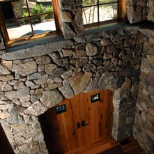 Interior foyer done in fieldstone with an arched entry doorway