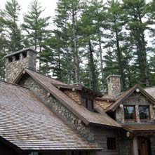 Two beautiful fieldstone chimneys with raised 6 thick granite caps on an Adirondack style home.