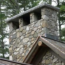 This magnificent fieldstone chimney is 10 feet wide and 9 feet tall with a 6 thick granite cap