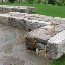Artistically and beautifully crafted antique granite and New England fieldstone wall designed by Chad P. Sanborn