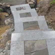 Step landings done in mosaic inlayed bluestone surrounded by granite