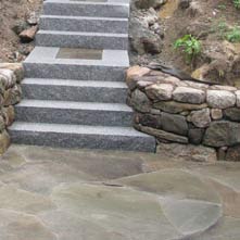 Granite steps with landings in mosaic inlayed bluestone surrounded by granite