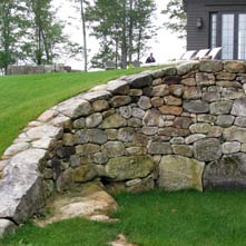 Large curved fieldstone retaining wall