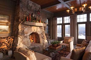 Rustic fireplace in three-season porch crafted by Chad Sanborn of Stone Age Design
